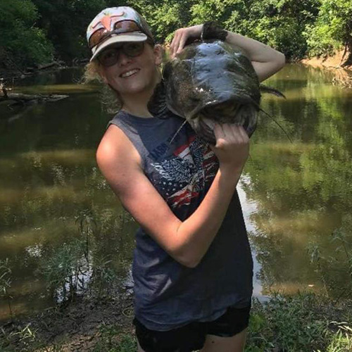 Boy holding giant catfish by Elk Falls RV Park