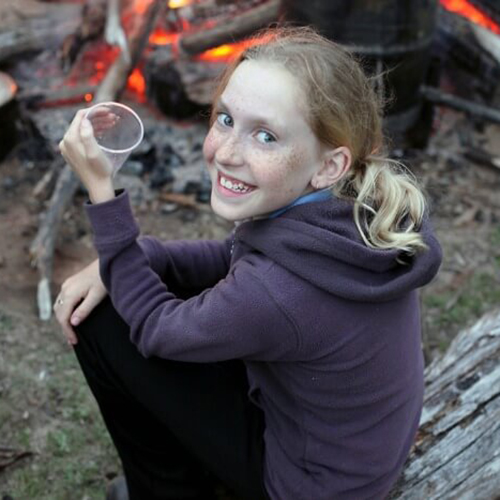 Teen enjoying a fire at Elk Falls RV Park