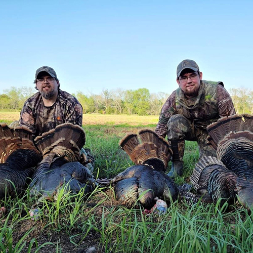 Hunters showing off four toms by Elk Falls RV Park